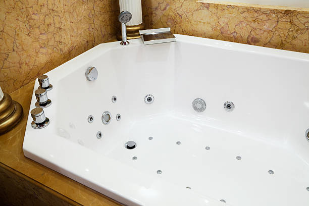 Luxury jetted tub installed with multiple water jets for hydrotherapy